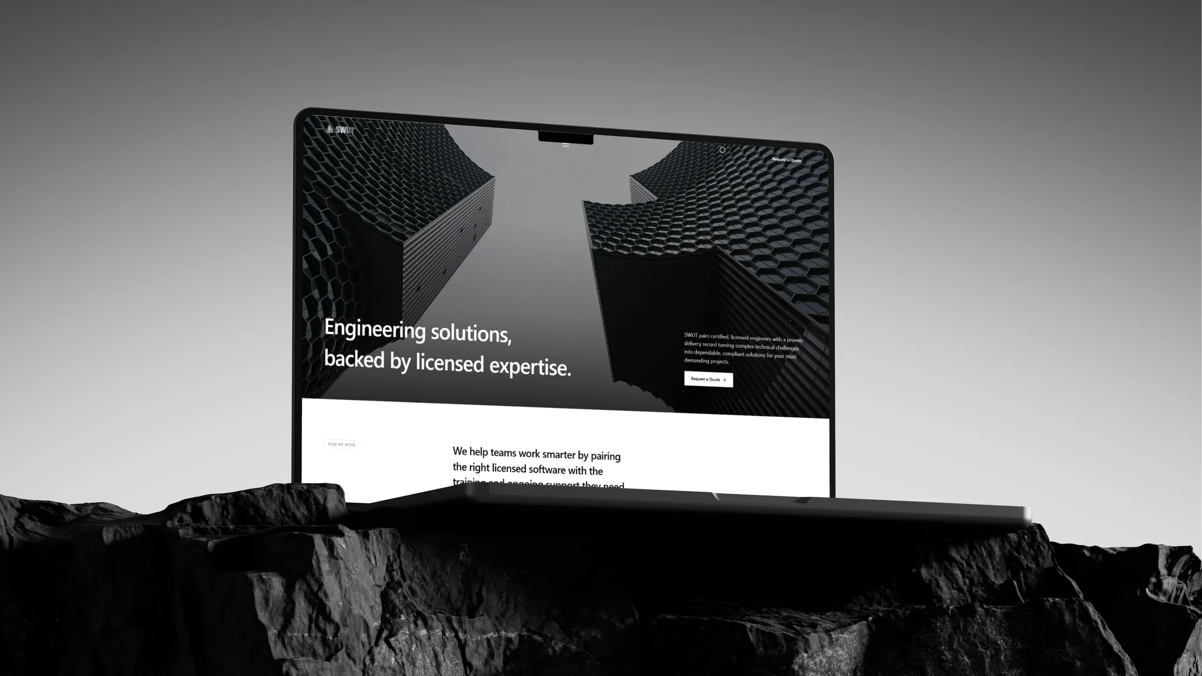 SWUT Solutions homepage shown on a laptop resting on dark stone